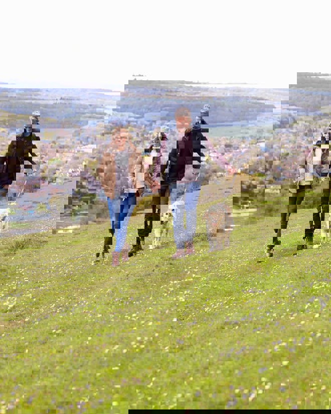 Elderly Couple Countryside Walk With Dog